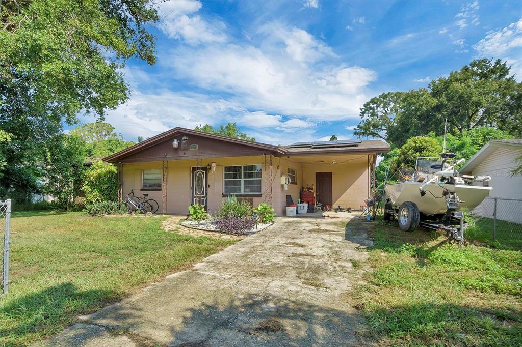 517 Marianna Road Auburndale, FL 33823 - Photo 2 of 37 a front view of a house with a garden and patio