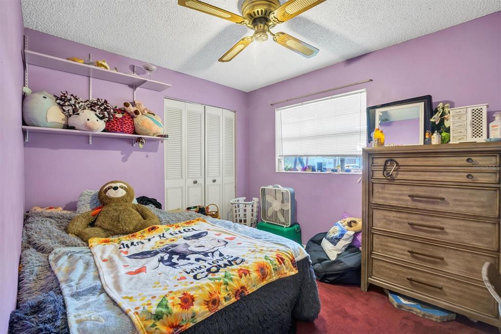 517 Marianna Road Auburndale, FL 33823 - Photo 23 of 37 a bedroom with a bed and dresser