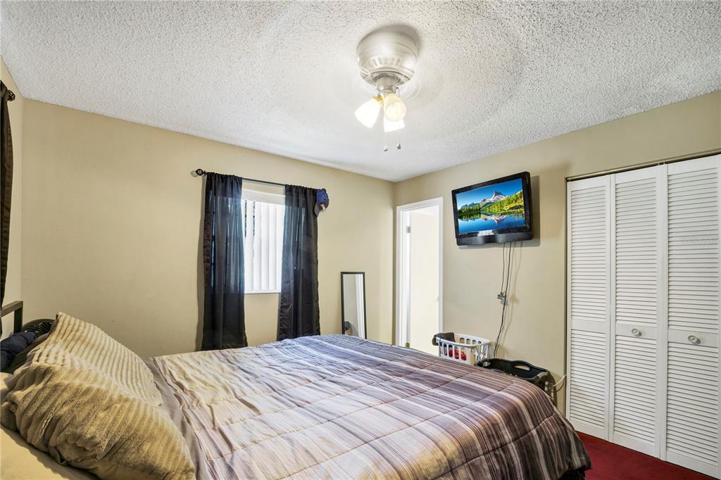 517 Marianna Road Auburndale, FL 33823 - Photo 7 of 37 a bedroom with a bed and a chandelier