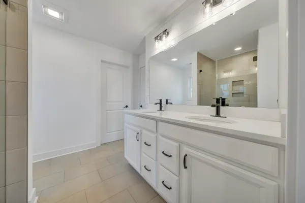 a bathroom with a double vanity sink mirror and