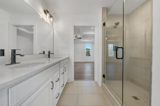 a spacious bathroom with a shower and a sink