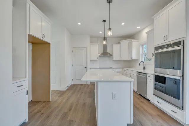 a kitchen with a stove sink and refrigerator