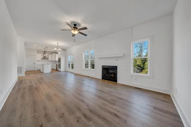 wooden floor in an empty room with a fireplace