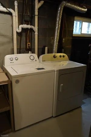 a bathroom with a sink a toilet a mirror and shower
