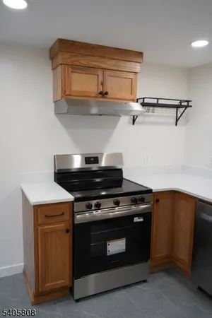a kitchen with stainless steel appliances a refrigerator and a stove