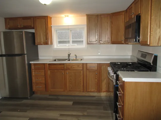 a kitchen with a sink a refrigerator and a stove