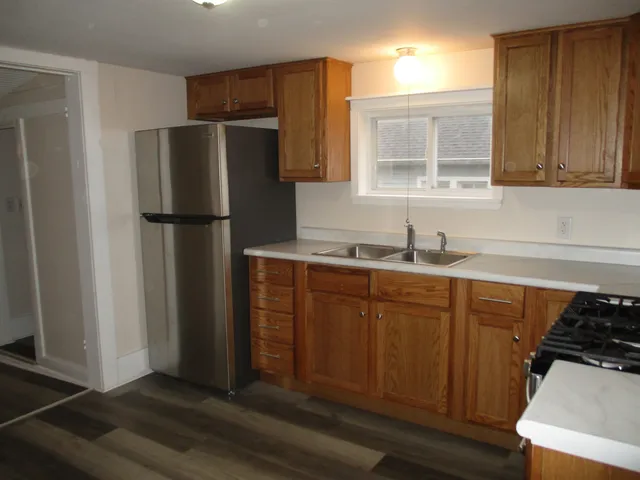 a kitchen with stainless steel appliances a refrigerator and sink