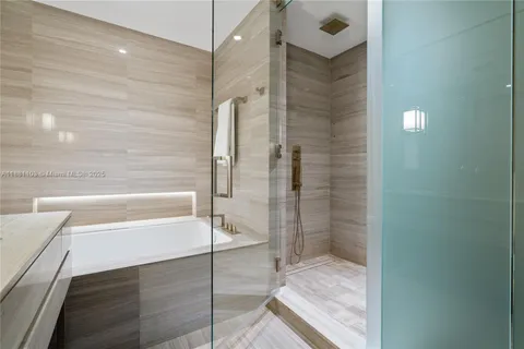 a bathroom with a shower and a tub