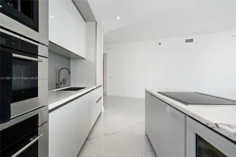 a kitchen with a sink and an oven