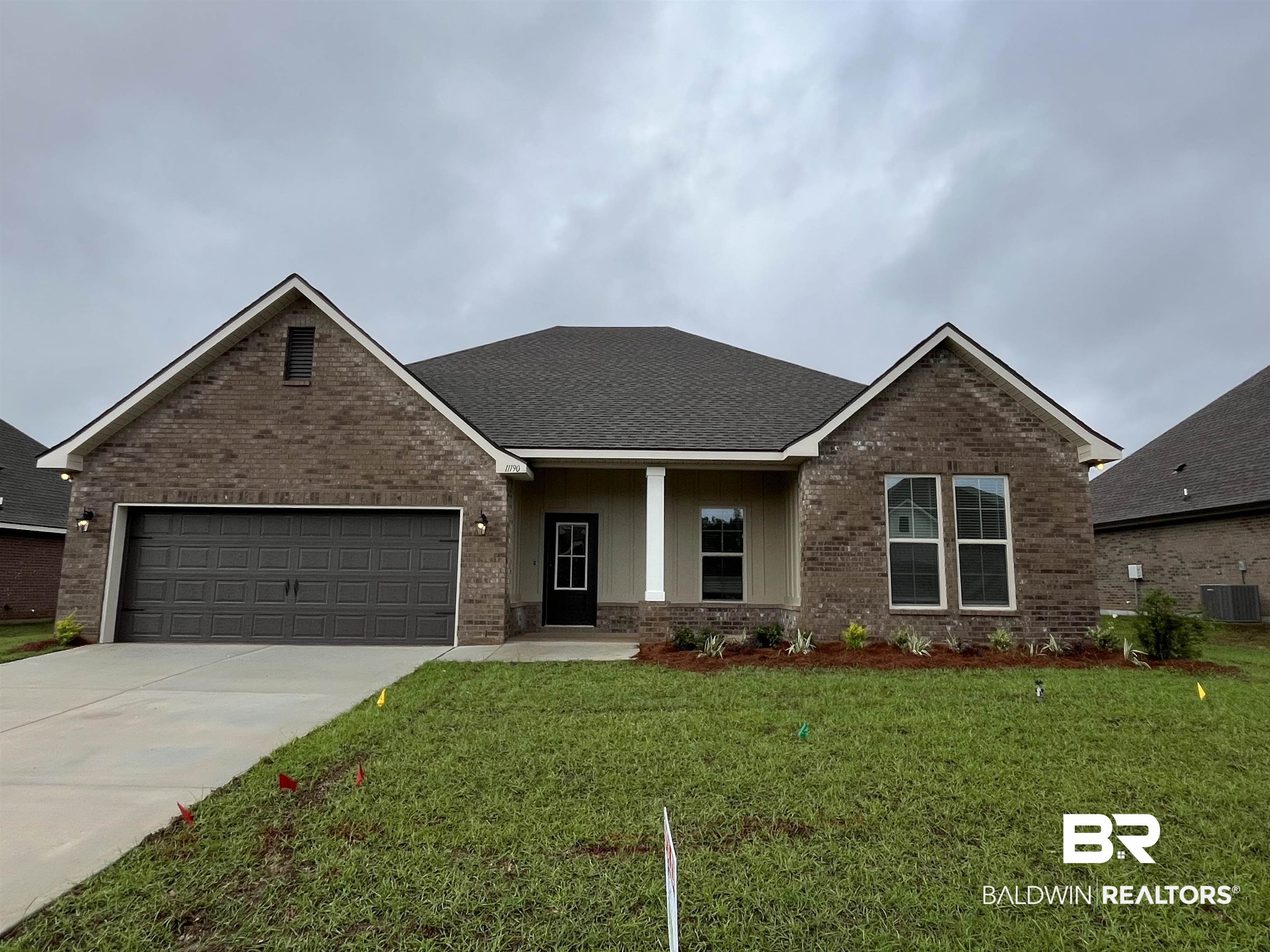 11190 Bonaventure Avenue Daphne, AL 36526 - Photo 1 of 3 Brick and siding exterior featuring a covered entry, gabled rooflines, and an attached two-car garage