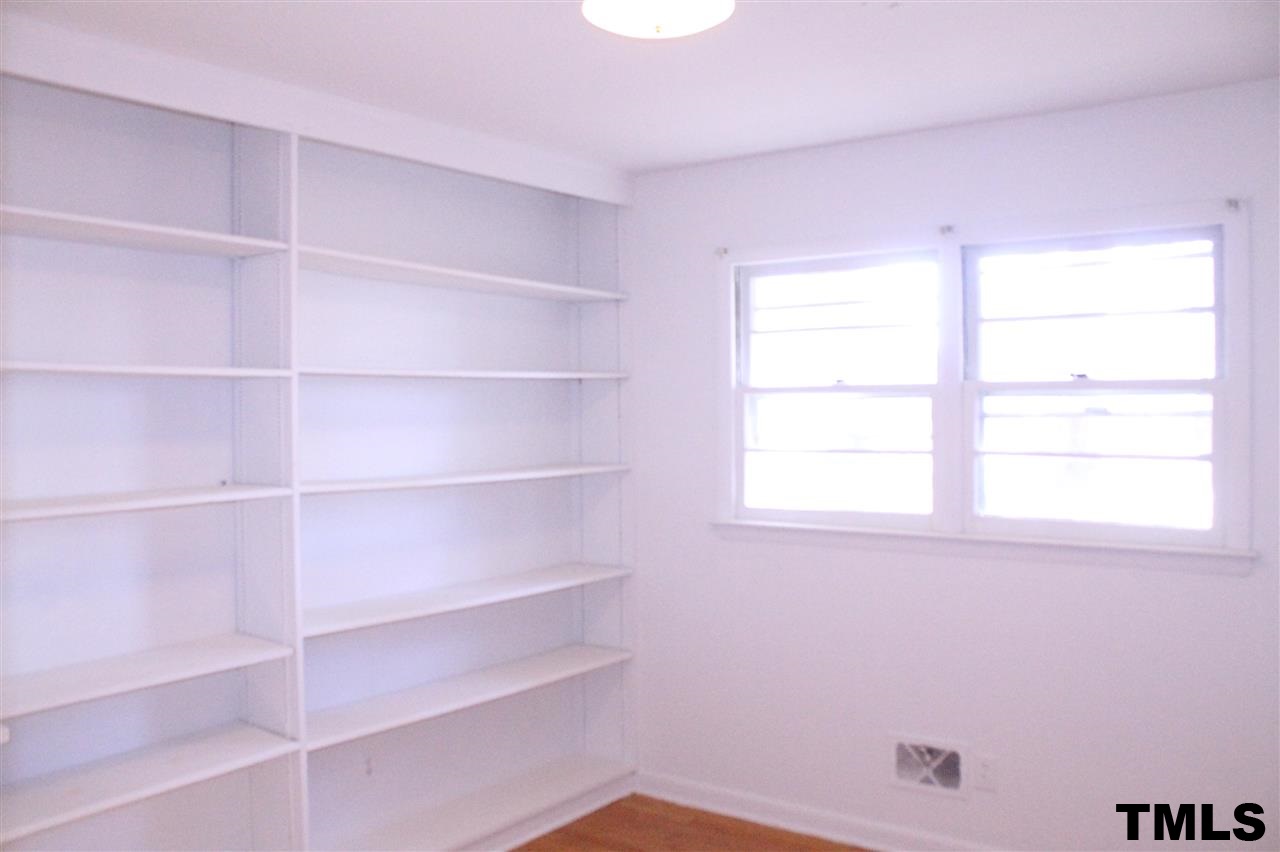 3900 Pearl Road Raleigh, NC 27610 - Photo 14 of 21 a view of a room with shelves and a window