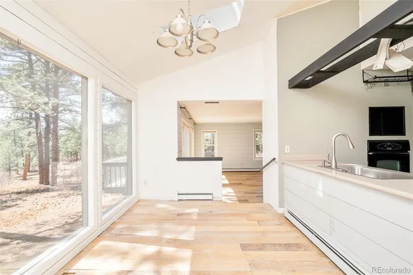 a spacious bathroom with a granite countertop sink a mirror and next to a window
