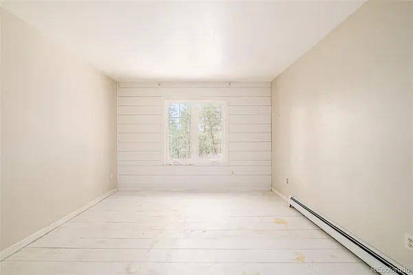 an empty room with a empty space and windows