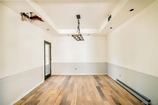 a view of empty room with wooden floor