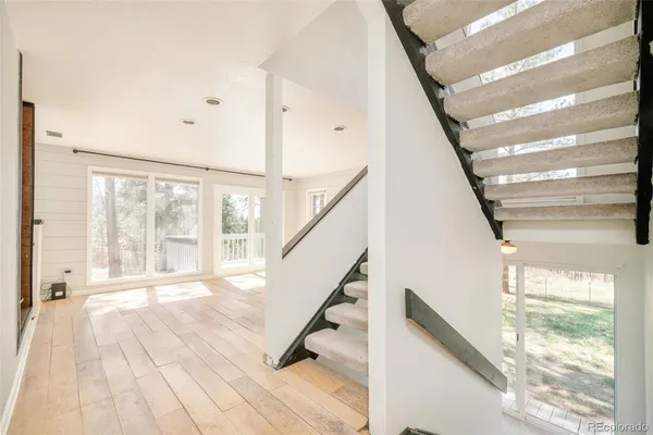 a view of an entryway with wooden floor and windows