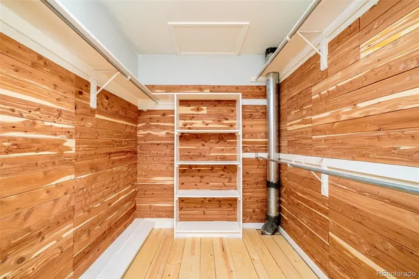 a view of a hallway with wooden floor and entryway