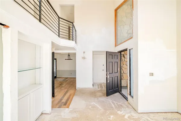 a view of a hallway with wooden shelves