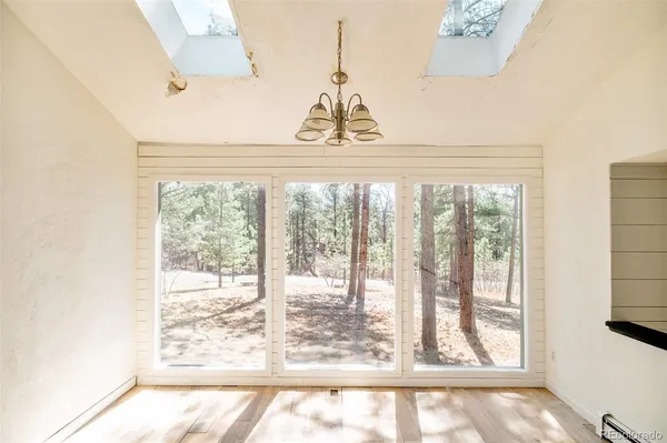 a view of a room with wooden floor and windows