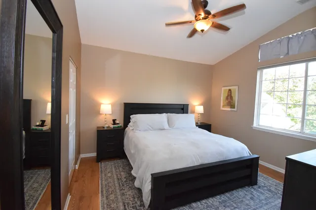 a bedroom with a bed and a chandelier