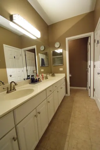 a spacious bathroom with a double vanity sink mirror and