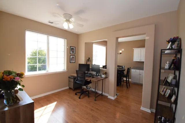 a view of a workspace with furniture and a window