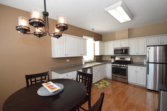 a kitchen with a sink appliances and cabinets
