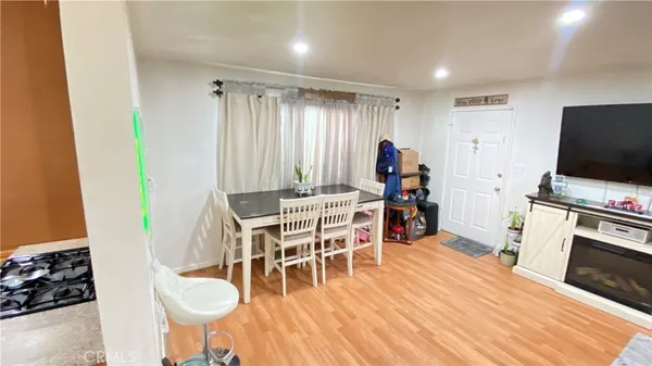 a dining room with furniture and wooden floor