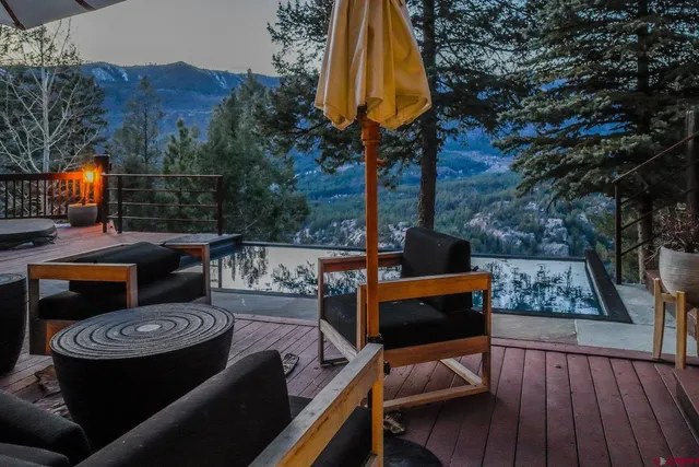 a living room with furniture a lamp and a floor to ceiling window