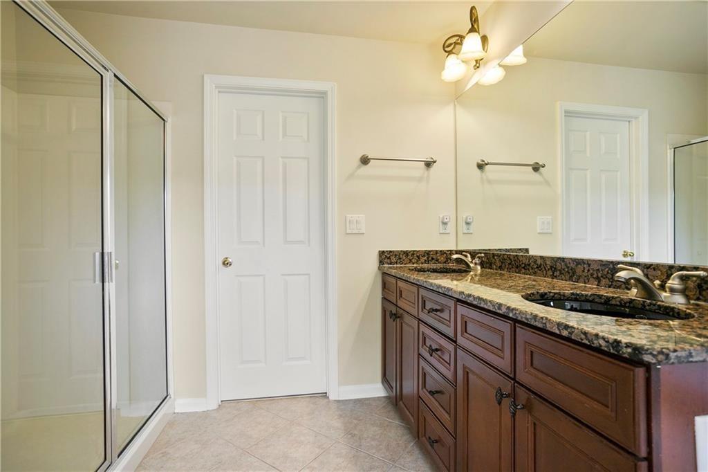6108 Joybrook Road Johns Creek, GA 30097 - Photo 12 of 22 a bathroom with a granite countertop sink and a mirror