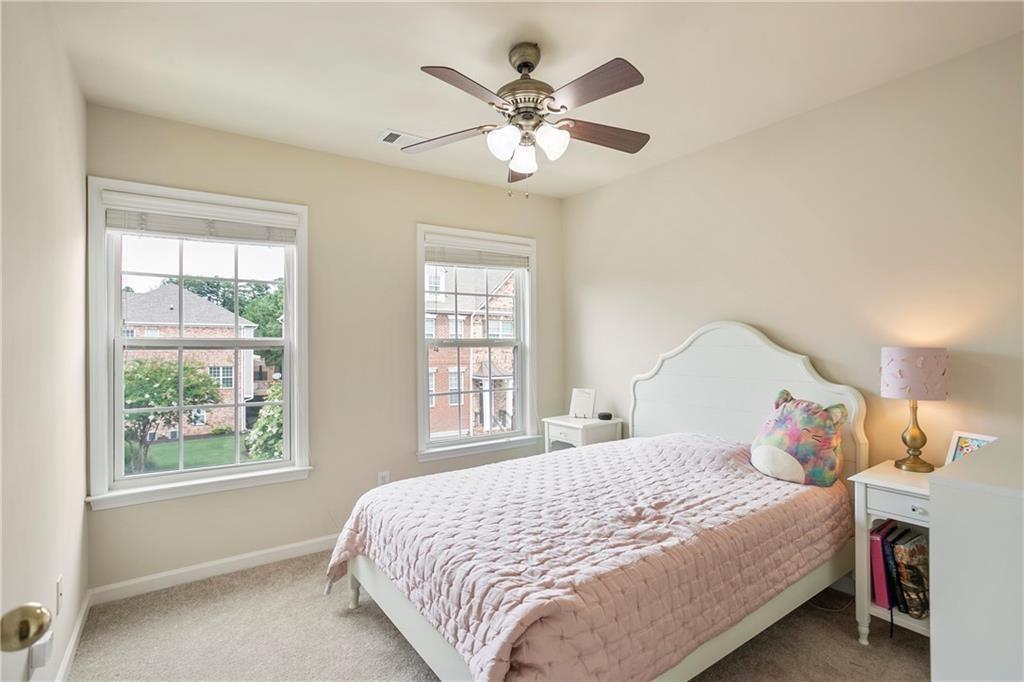 6108 Joybrook Road Johns Creek, GA 30097 - Photo 15 of 22 a bedroom with a large bed and a chandelier