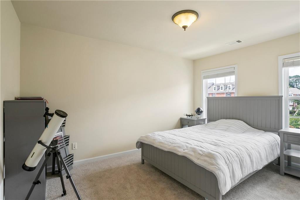 6108 Joybrook Road Johns Creek, GA 30097 - Photo 17 of 22 a bedroom with a bed and a ceiling fan