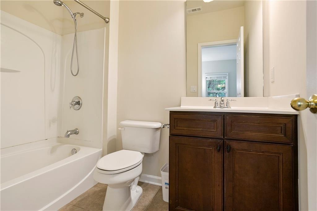 6108 Joybrook Road Johns Creek, GA 30097 - Photo 20 of 22 a bathroom with a sink a toilet and shower