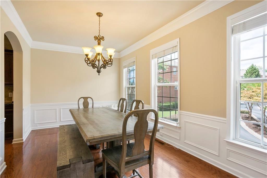 6108 Joybrook Road Johns Creek, GA 30097 - Photo 2 of 22 a view of a dining room with furniture a chandelier and wooden floor
