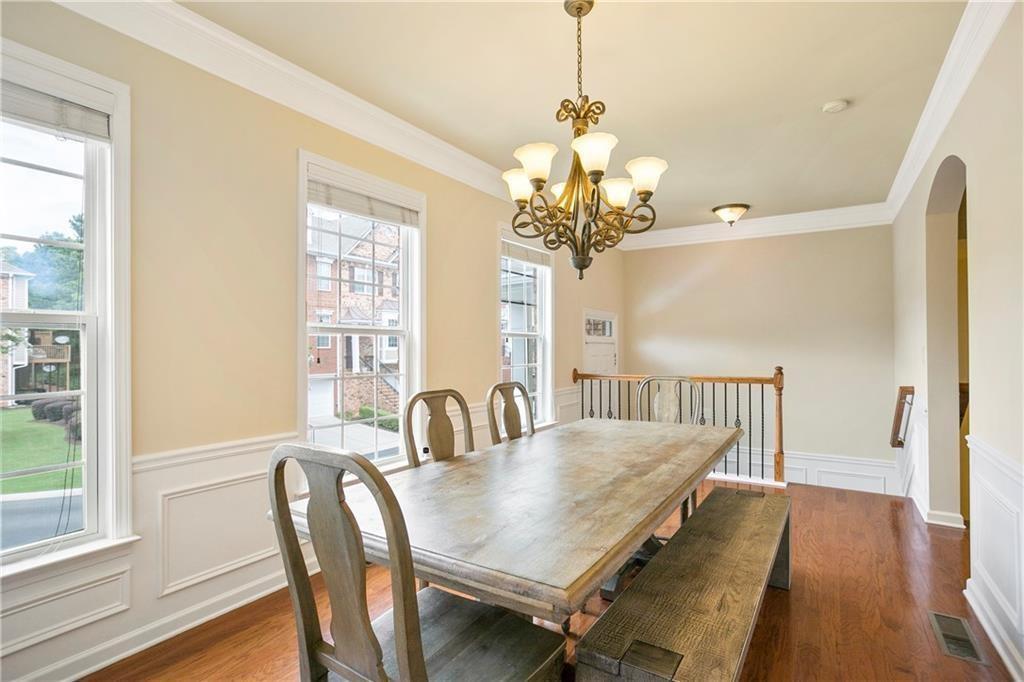 6108 Joybrook Road Johns Creek, GA 30097 - Photo 3 of 22 a view of a dining room with furniture a chandelier and wooden floor
