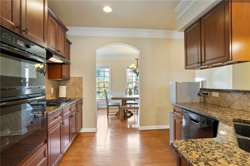6108 Joybrook Road Johns Creek, GA 30097 - Photo 5 of 22 a kitchen with stainless steel appliances granite countertop a stove a sink and a refrigerator