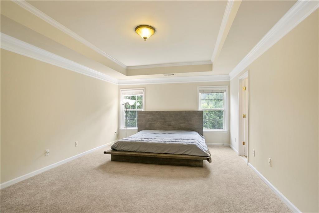 6108 Joybrook Road Johns Creek, GA 30097 - Photo 10 of 22 a bedroom with a bed and lamp