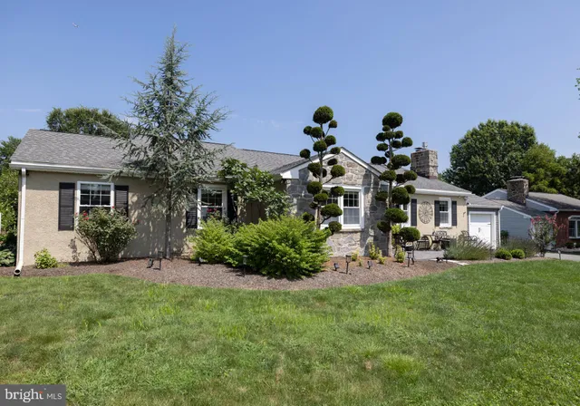 a view of a house with a yard and sitting area