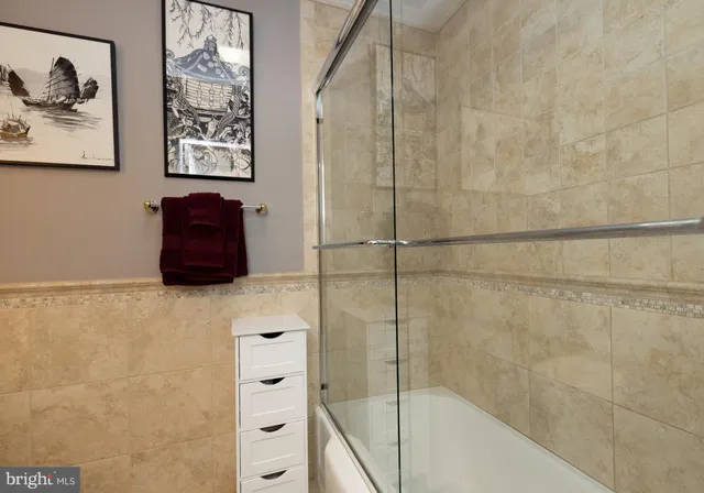 a bathroom with a bathtub and shower