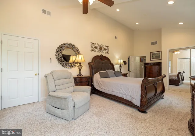 a bedroom with a bed couch and window