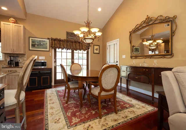 a living room with furniture a chandelier and a dining table