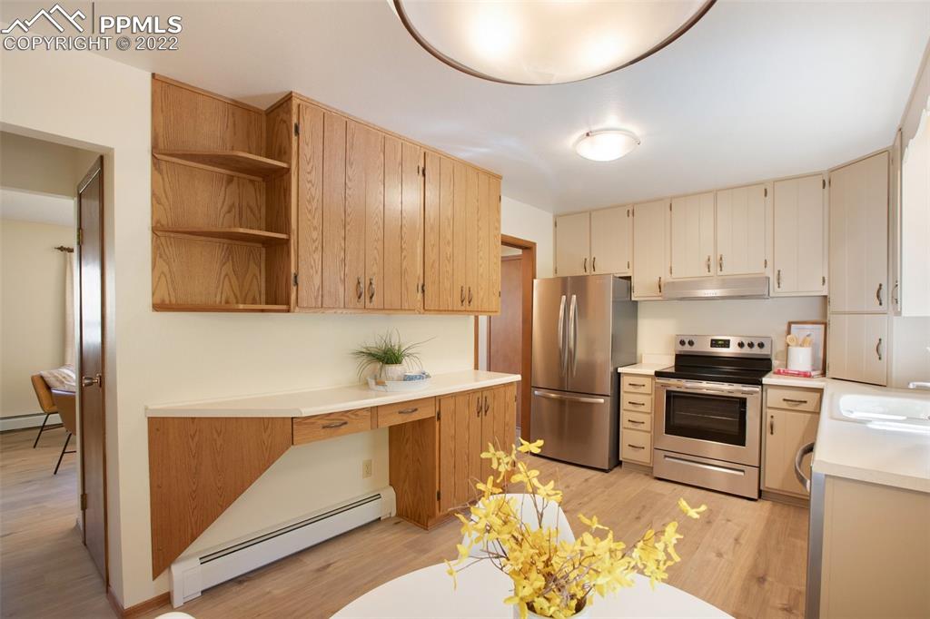9610 Mohawk Trail Cascade, CO 80809 - Photo 12 of 38 a kitchen with stainless steel appliances granite countertop a refrigerator sink and cabinets