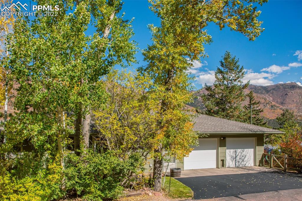 9610 Mohawk Trail Cascade, CO 80809 - Photo 2 of 38 a front view of a house with garden