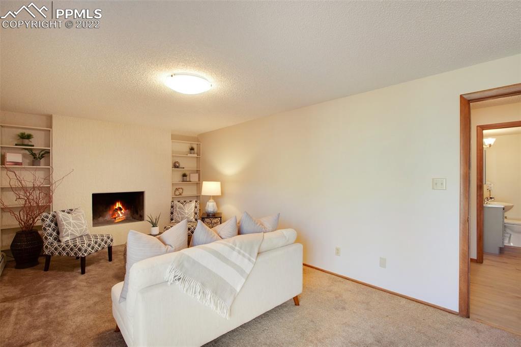 9610 Mohawk Trail Cascade, CO 80809 - Photo 21 of 38 a living room with furniture and a flat screen tv