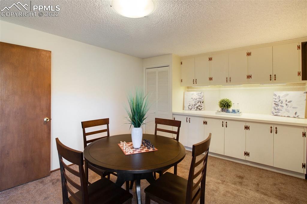 9610 Mohawk Trail Cascade, CO 80809 - Photo 23 of 38 a view of kitchen with a table and chairs in it
