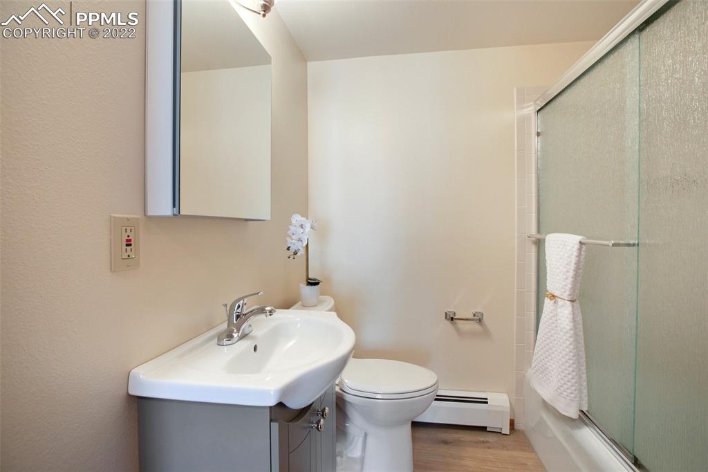 9610 Mohawk Trail Cascade, CO 80809 - Photo 25 of 38 a bathroom with a sink toilet and mirror