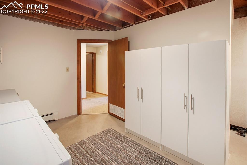 9610 Mohawk Trail Cascade, CO 80809 - Photo 28 of 38 a view of a storage & utility room with wooden floor