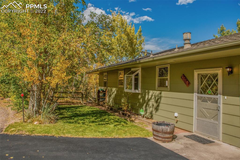 9610 Mohawk Trail Cascade, CO 80809 - Photo 3 of 38 a view of house with backyard