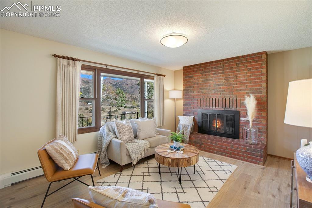 9610 Mohawk Trail Cascade, CO 80809 - Photo 6 of 38 a living room with furniture and a fireplace