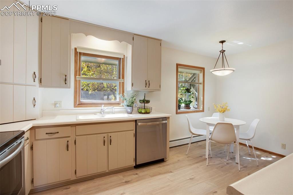 9610 Mohawk Trail Cascade, CO 80809 - Photo 9 of 38 a large white kitchen with a window and furniture