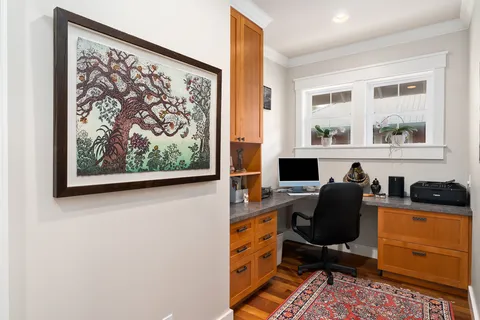 a view of a workspace with furniture and a window